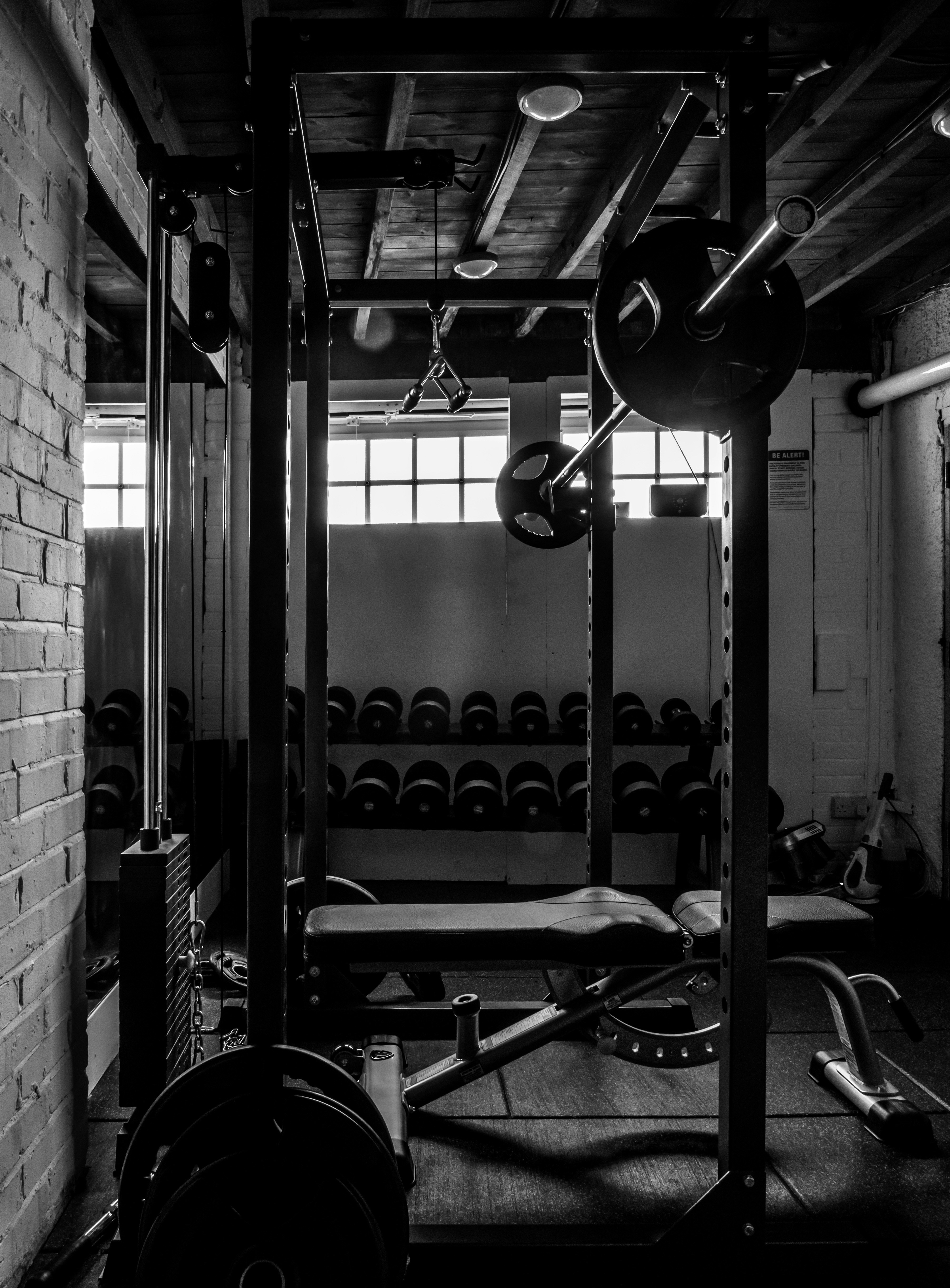 Certified personal trainer guiding a client through weight training